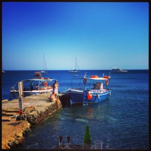 Once you visit Akrotiri, take a caique to the nearby beaches of Santorini