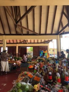 A market selling fresh fruit, bottled cocktails and spices in Martinique